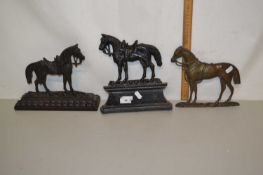 Two iron door stops modelled as horses plus a similar plaque (3)