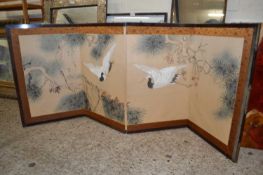 A small 20th Century Oriental three fold screen decorated with cranes