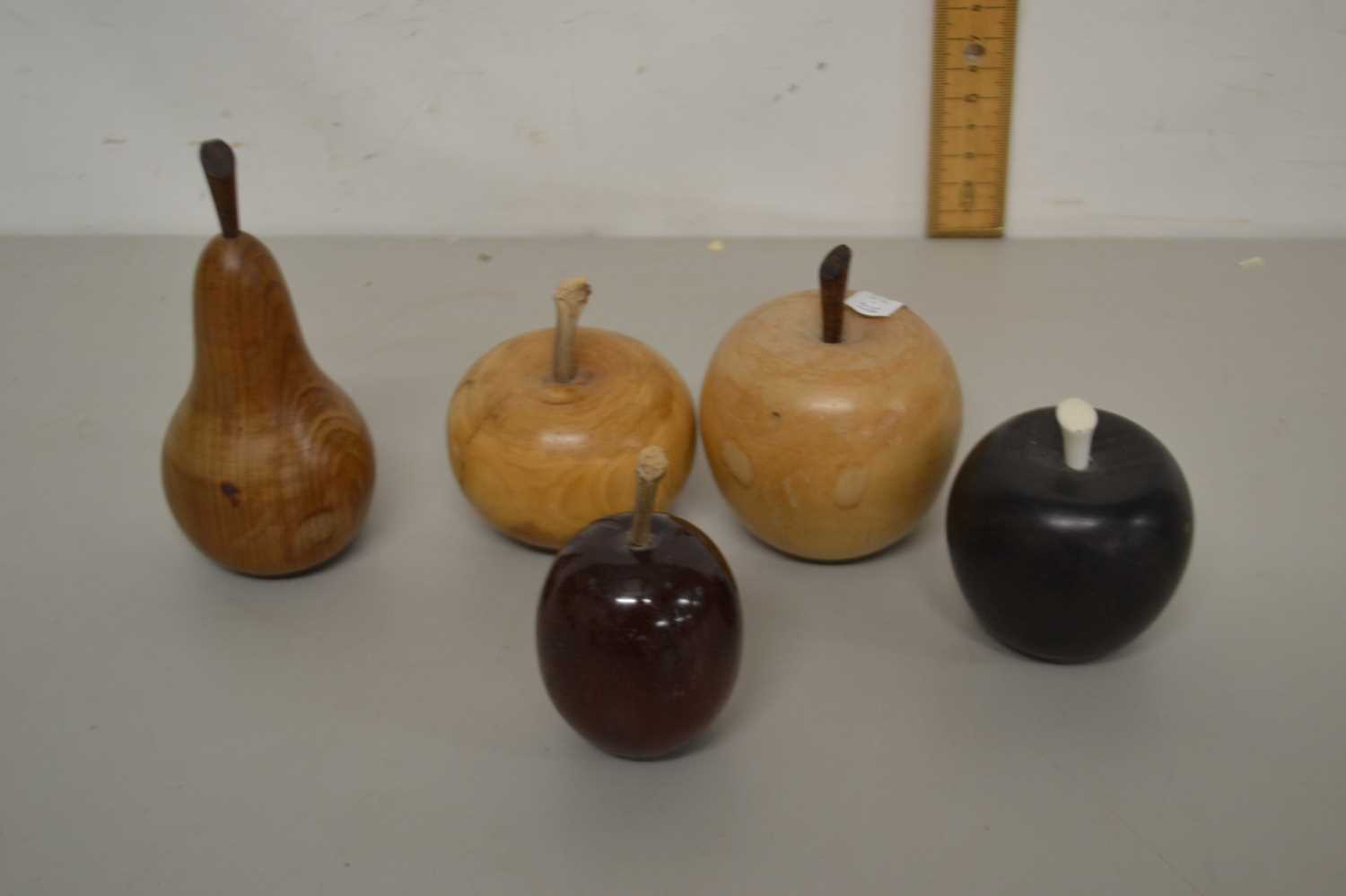 A group of various turned wooden fruit