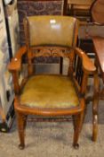 An early 20th Century oak framed and leather desk chair