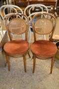 A pair of bent wood and cane cafe chairs