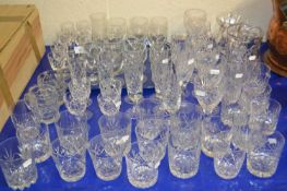 A large collection of various clear drinking glasses