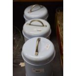 Three pale blue storage cannisters