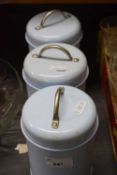 Three pale blue storage cannisters