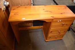 A pine desk with three drawers