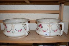 A pair of floral decorated chamber pots