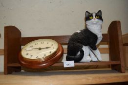 Freestanding bookshelf with wall clock and resin model cat