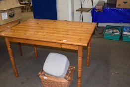 A rectangular pine topped kitchen table