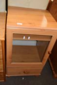 A pine glazed cupboard with drawer below