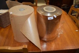 A roll of brown paper and a roll of cellophane
