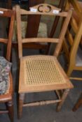 A rattan seated dining chair