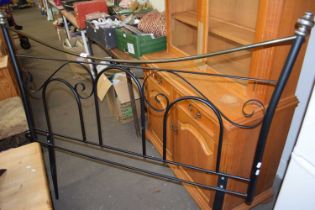 A black metal framed bed end