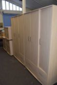 Two triple door wardrobes with drawers below together with a chest of drawers and a pair of
