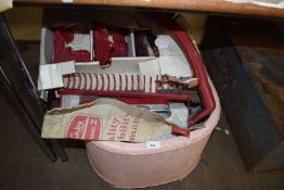 A pink linen bin together with a Kirby Classic carpet cleaner