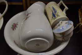 A white and pink floral decorated wash bowl and jug together with others