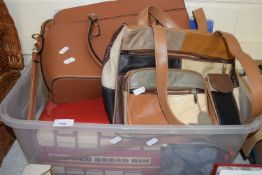 A big red bread bin in the shape of a bus together with a quantity of ladies bags and accessories