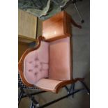 A pink upholstered telephone table