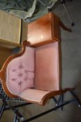 A pink upholstered telephone table