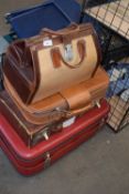 Three suitcases and a Gladstone style bag