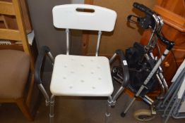 A bath chair and folding walker and walking stick