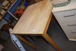 A square pine topped kitchen table
