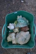 Plastic container with various small concrete animal ornaments