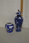 A Chinese prunus pattern covered vase and a further smaller example, larger vase with chips