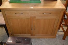 A modern oak combination sideboard and workstation with slide out front