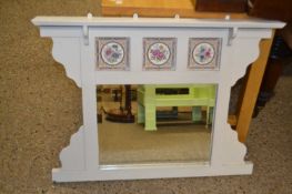 An over mantel mirror with tile inset frame