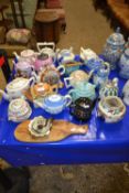 A large collection of various decorative and novelty teapots to include Royal Doulton and others