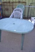 Plastic garden table and a quantity of stacking chairs