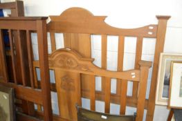 An Edwardian American walnut double bed frame