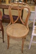A bent wood chair with cane seat