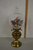Brass based oil lamp with shade decorated with a hunting scene