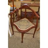 An Edwardian corner chair with floral upholstered seat