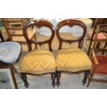 A pair of mahogany framed balloon backed dining chairs
