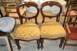 A pair of mahogany framed balloon backed dining chairs