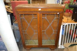 An oak and lead glazed bookcase