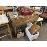 A pine drop leaf table with single drawer