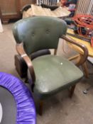 A green leatherette upholstered elbow chair