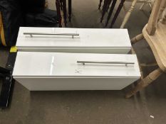 A pair of white melamine and chrome handled slim line kitchen cupboards