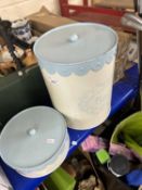 A blue and cream bread bin and matching biscuit tin