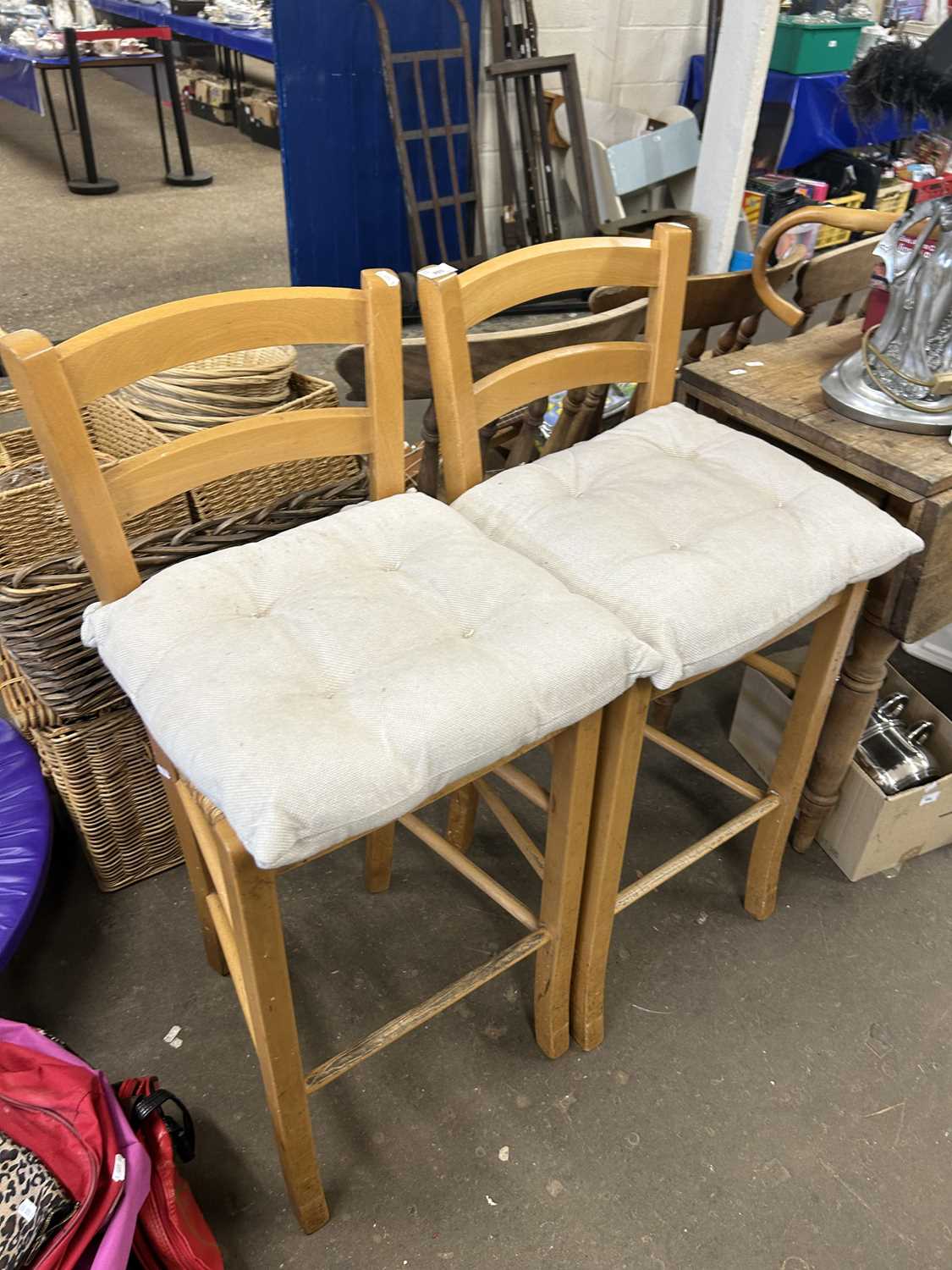 A pair of pine and rush seated bar stools together with cream tie on John Lewis cushions