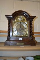 A 1925 oak cased mantel clock with brass dial