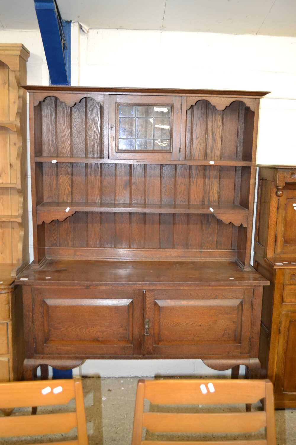 An Edwardian oak dresser with two door base