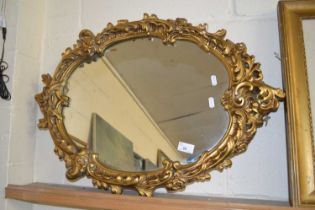 A plasterwork framed wall mirror with gilt floral detail