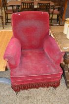 Late Victorian red upholstered armchair on turned legs