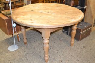 Circular pine dining table on turned legs
