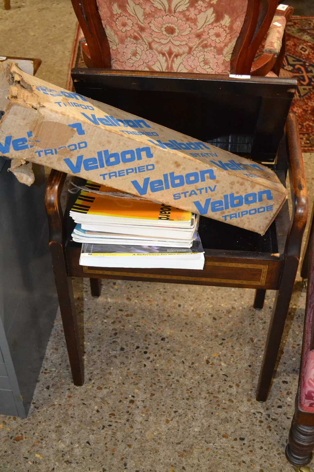 A floral upholstered piano stool, sheet music and tripod