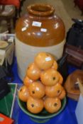 Large unbranded stone ware jar together with a pottery bowl of oranges